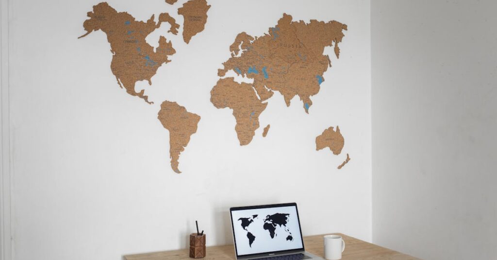 A minimalist workspace with a laptop and cork world map wall art.